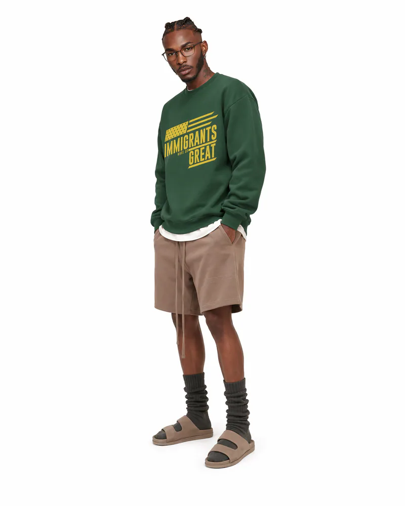 The Sovereign Crewneck Vanguard in Legacy Green, worn, three-quarter view